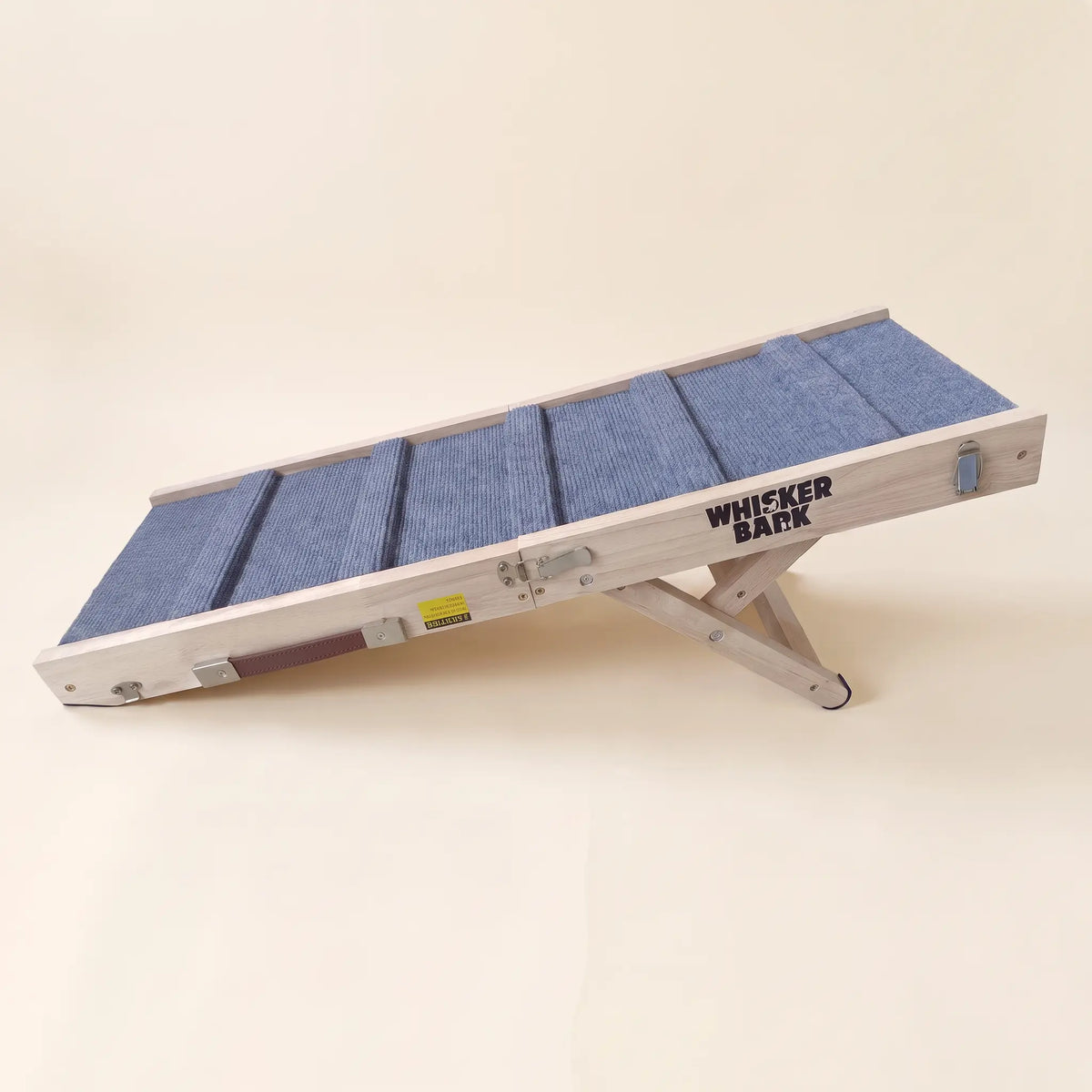 Whisker Bark folding dog ramp in the whitewash finish, set up on a cream background.